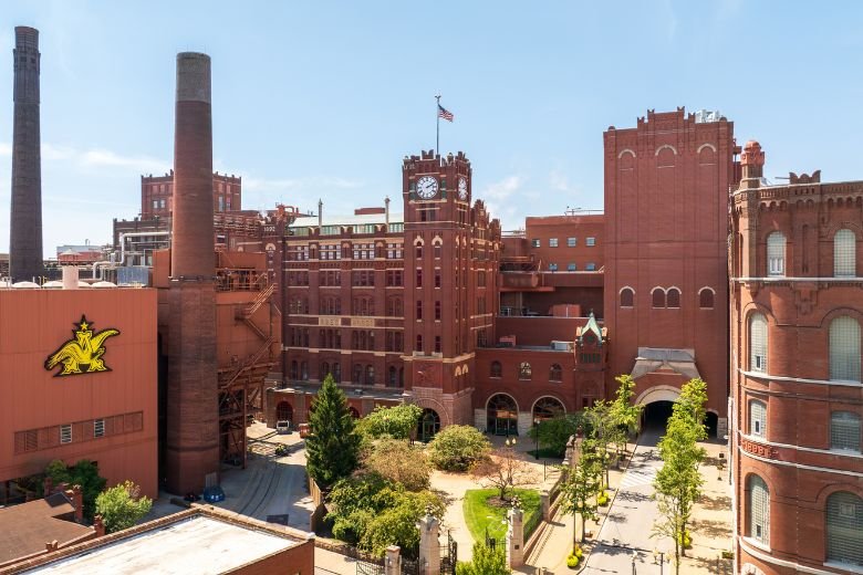 Anheuser-Busch brewery, St Louis — historic brick complex with twin smokestacks and clock tower